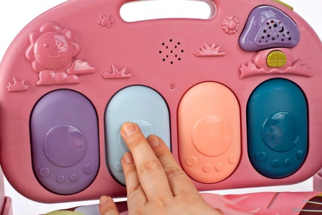 Roze educatieve speelkleed met piano en rammelaars