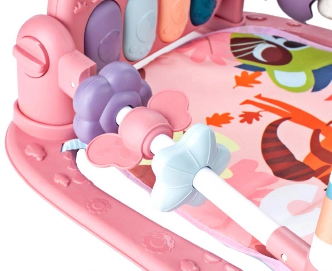 Roze educatieve speelkleed met piano en rammelaars